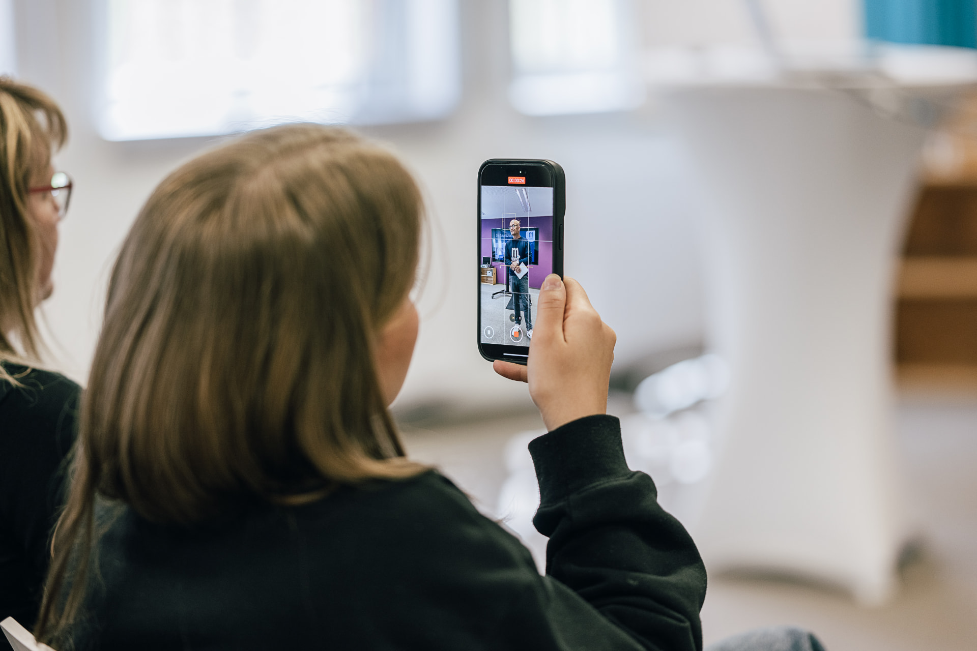 Teilnehmende filmt im Workshop mit dem Smartphone